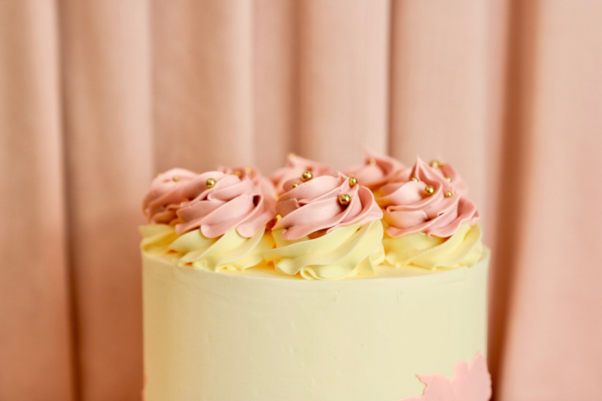 The pastel cake, created with layers of white, pink, and yellow to resemble the signature colors of our store Cafe Pastel.