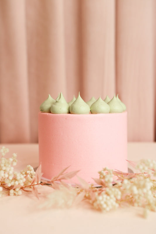 Pink bento cake with green decor on top